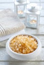 Bowl of yellow sea salt, two soft towels and vintage birdcage wi Royalty Free Stock Photo