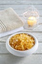 Bowl of yellow sea salt, two soft towels and vintage birdcage wi Royalty Free Stock Photo