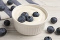 Bowl of yogurt with blueberries served on white wooden table Royalty Free Stock Photo