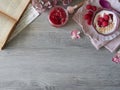 Bowl with yogurt and raspberry jam on wooden table.