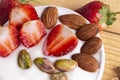 Bowl of yogurt, red fruit strawberry and dried fruit on the wood table. Yogurt made from milk fermented by added bacteria, often Royalty Free Stock Photo