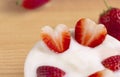 Bowl of yogurt and red fruit strawberry on the wood table. Yogurt made from milk fermented by added bacteria, often sweetened and Royalty Free Stock Photo