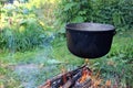 Over the fire hangs a cooking bowl Royalty Free Stock Photo