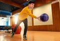 Bowler player prepares to release purple ball in modern bowling alley Royalty Free Stock Photo