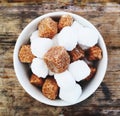 A bowlful of brown and white sugar cubes