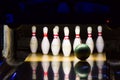 Bowling alley. Green bowling ball rolling into the pins Royalty Free Stock Photo