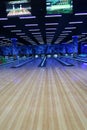 a bowling alley with a row of bowling lanes and televisions above it Royalty Free Stock Photo