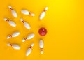 Bowling ball hits all the skittles on yellow background