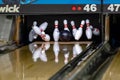 Bowling ball hitting pins at a bowling alley Royalty Free Stock Photo