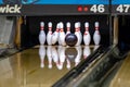 Bowling ball hitting pins at a bowling alley Royalty Free Stock Photo