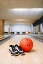 Bowling ball and house shoes on lane in club