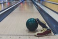Bowling ball and shoes on lane background Royalty Free Stock Photo