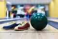 Bowling ball and shoes on lane background Royalty Free Stock Photo