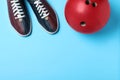 Bowling ball and shoes on light blue background. Space for text Royalty Free Stock Photo