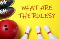 Bowling ball, shoes, pins and text WHAT ARE THE RULES? on background, flat lay Royalty Free Stock Photo