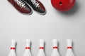 Bowling ball, shoes and pins on white background