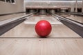 Red bowling ball on the track in the bowling center Royalty Free Stock Photo