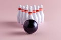 Bowling ball and white skittles on pastel pink background. Minimal creative concept Royalty Free Stock Photo