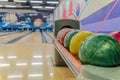 Bowling balls against background of empty lanes in bowling alley. Active leisure