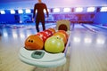 Bowling balls at bowl lift with ultraviolet lighting