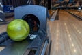 Bowling balls lie in a holder in a line. Colored balls and bowling lane.