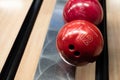 Brunswick bowling balls lined up on a track