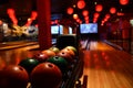 Bowling lane and balls in the row in bowling center. Royalty Free Stock Photo