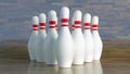 Bowling pins, white with red stripes aligned to get hit by a bowling ball