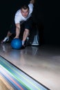 Bowling player makes a blue ball move, close-up