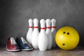 Bowling shoes, pins and ball on grey marble table Royalty Free Stock Photo