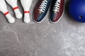 Bowling shoes, pins and ball on grey marble table, flat lay. Space for text Royalty Free Stock Photo