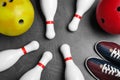 Bowling shoes, pins and balls on grey stone table, flat lay Royalty Free Stock Photo