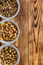 Bowls of assorted nuts on a rustic wood table