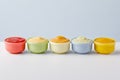 Bowls with baby food on grey background. Generative AI