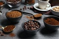 Bowls of beans, instant and ground coffee on grey table Royalty Free Stock Photo