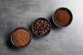 Bowls of beans, instant and ground coffee on grey table, flat lay Royalty Free Stock Photo