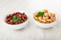 Bowls with canned white beans and red beans on wooden table