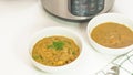 Bowls of a creamy lentil soup close up on white kitchen table. Multi cooker lentil soup recipe Royalty Free Stock Photo