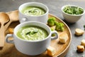 Bowls of delicious broccoli cream soup with microgreens