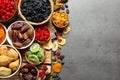 Bowls of different dried fruits on grey background, top view with space for text. Royalty Free Stock Photo