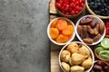 Bowls of different dried fruits on grey background, top view with space for text. Royalty Free Stock Photo