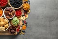 Bowls of different dried fruits on grey background, top view with space for text. Royalty Free Stock Photo