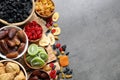 Bowls of different dried fruits on grey background, top view with space for text. Royalty Free Stock Photo