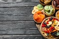 Bowls of different dried fruits on wooden background, space for text. Healthy lifestyle Royalty Free Stock Photo