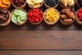 Bowls of different dried fruits on wooden background, top view with space for text Royalty Free Stock Photo