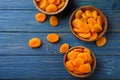 Bowls with dried apricots on wooden table Royalty Free Stock Photo