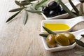 In the bowls extra virgin olive oil and organic olives