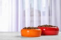 Bowls with food for cat and dog on floor Royalty Free Stock Photo