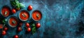Bowls of Fresh Tomato Soup with Basil on Rustic Blue Background, Top View with Copy Space Royalty Free Stock Photo