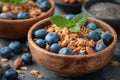 Bowls of granola- blueberries- black chia seeds.